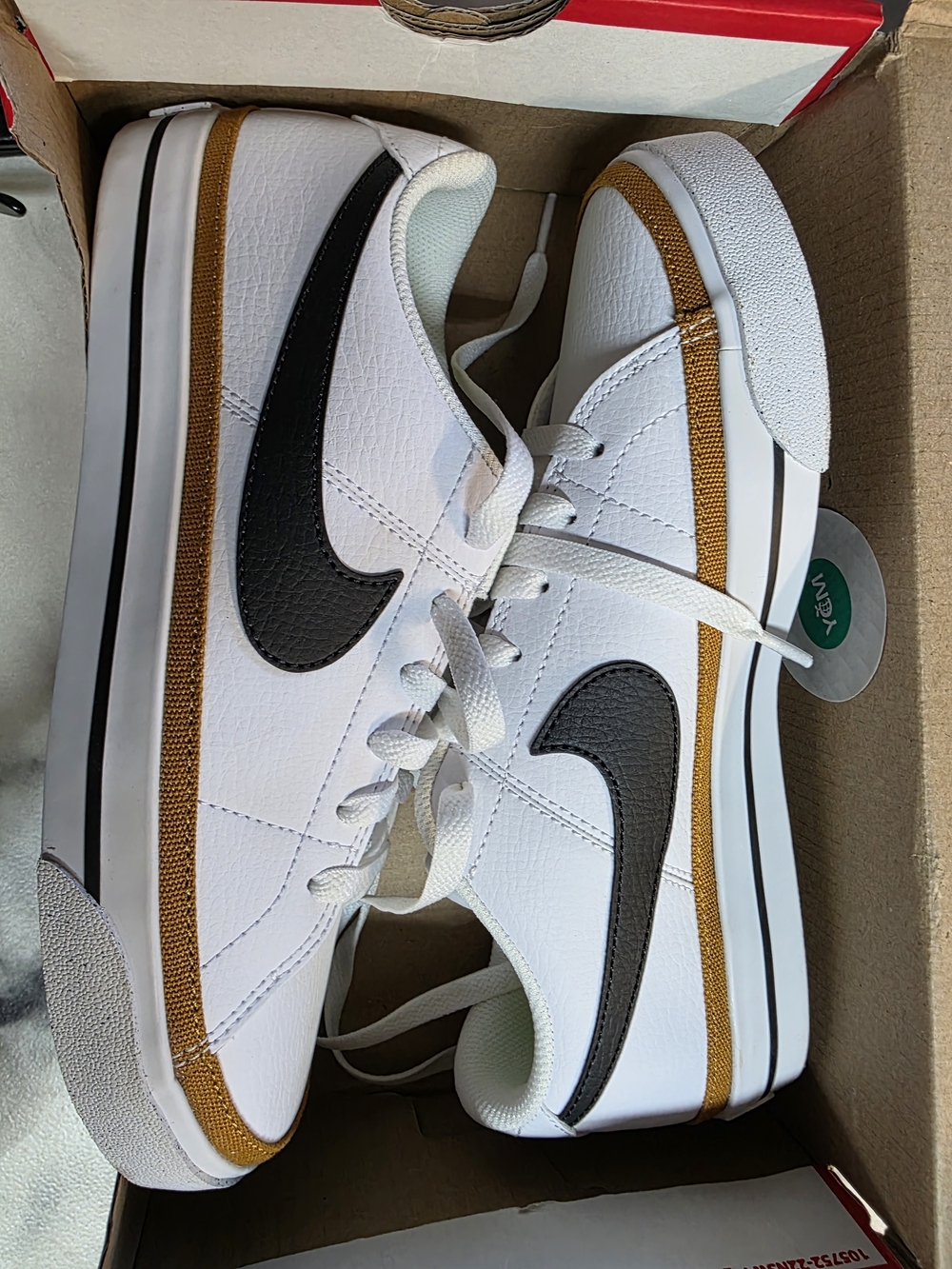 Nike White Low-Top Sneakers with Black Swoosh and Gold Trim - Women